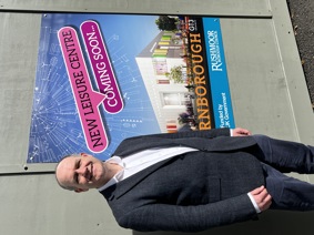 Leader of council with image of new leisure centre