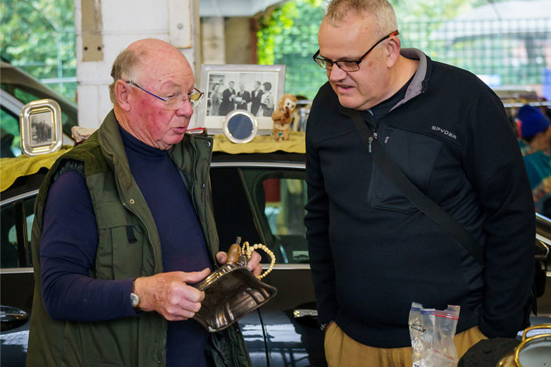 Car Boot Sellers Looking At Items
