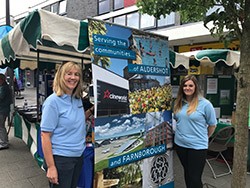 Rushmoor Borough Council staff advertising volunteering opportunities at a stand in the town centre
